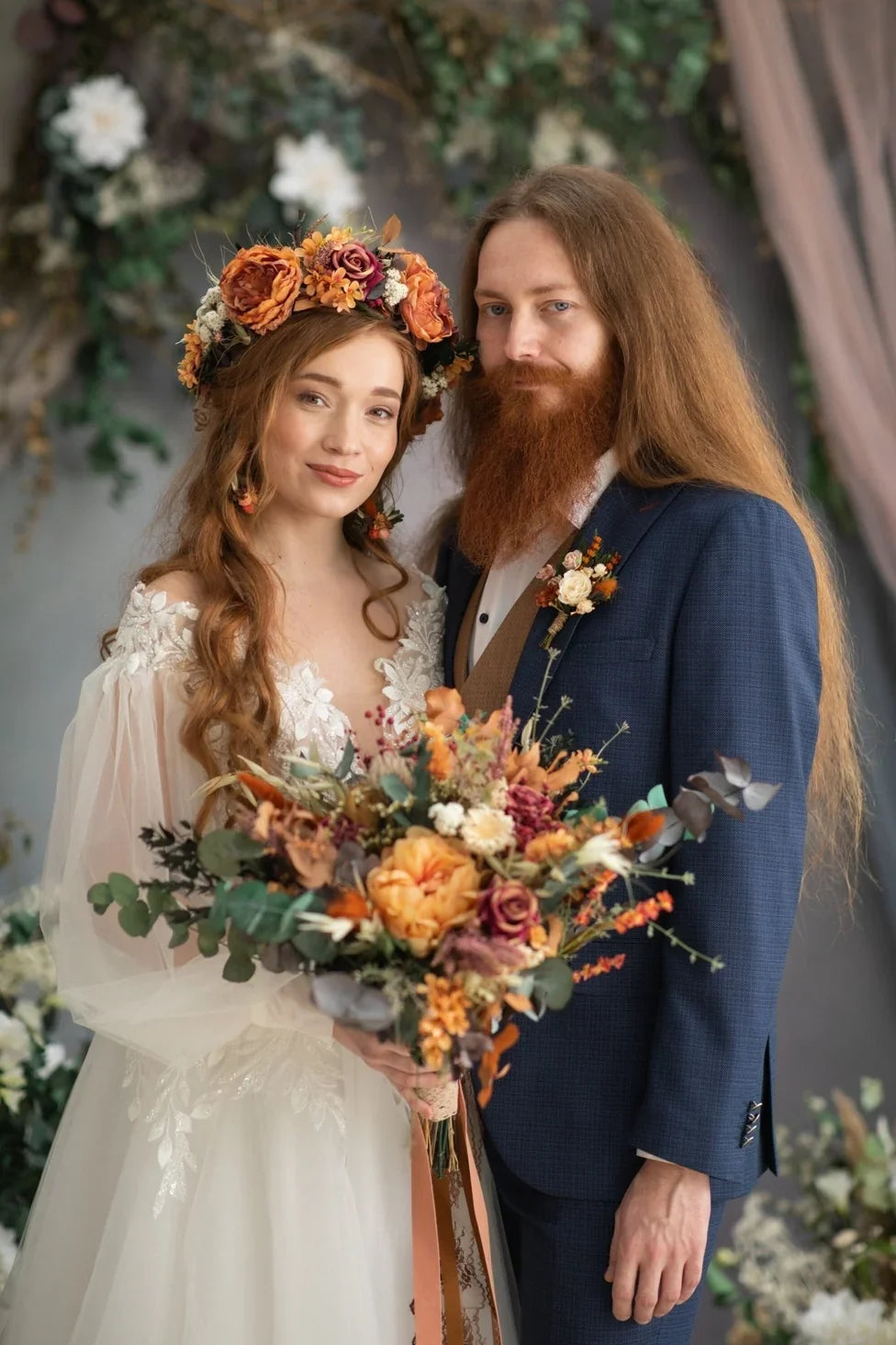 Bride wearing a flower hair comb and groom wearing a boutonniere  with autumn flowers for a romantic fall wedding