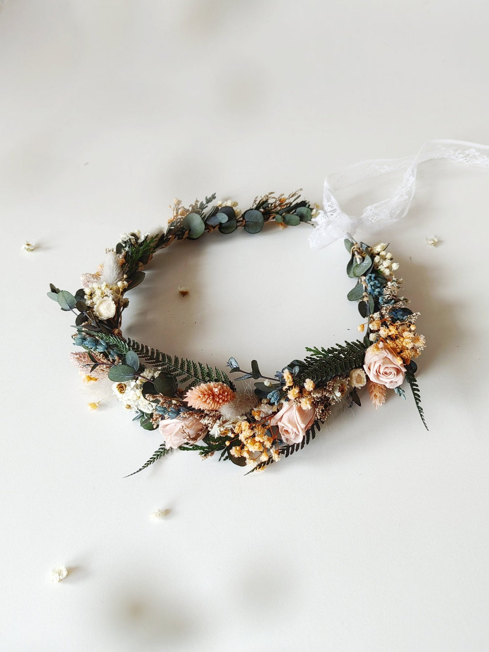 Floral dried wreath with greenery and  blush flowers on a white background