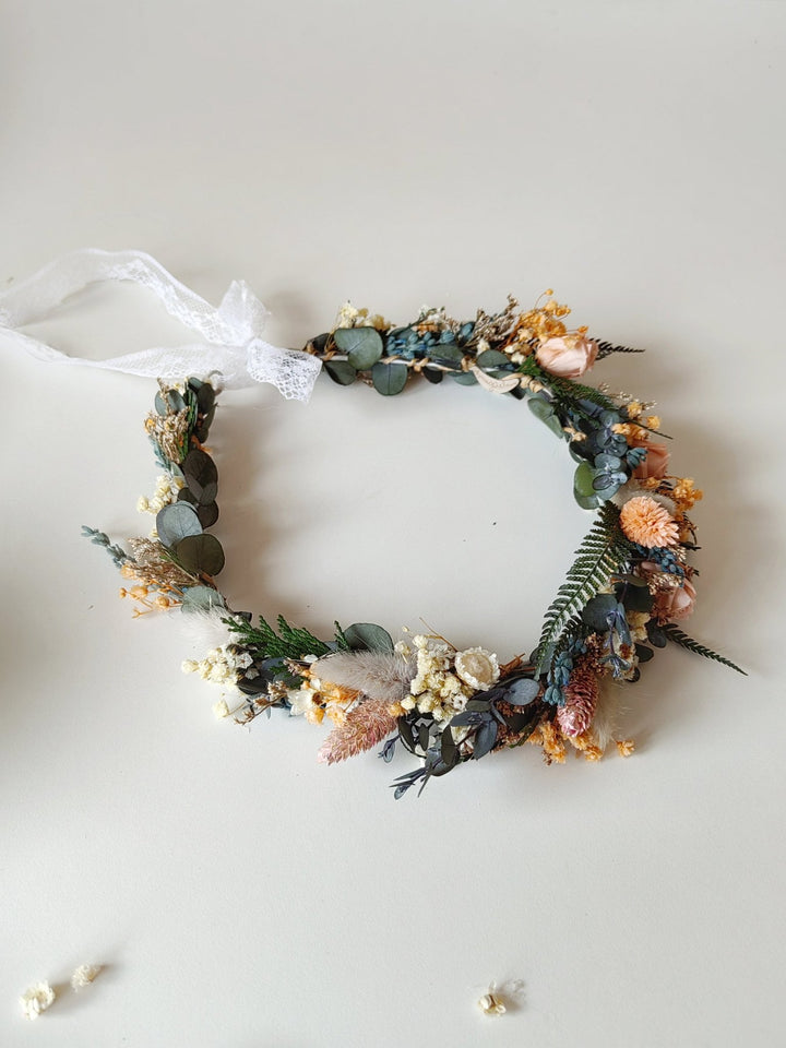 Floral bridal crown with greenery and dried blush flowers on a white background
