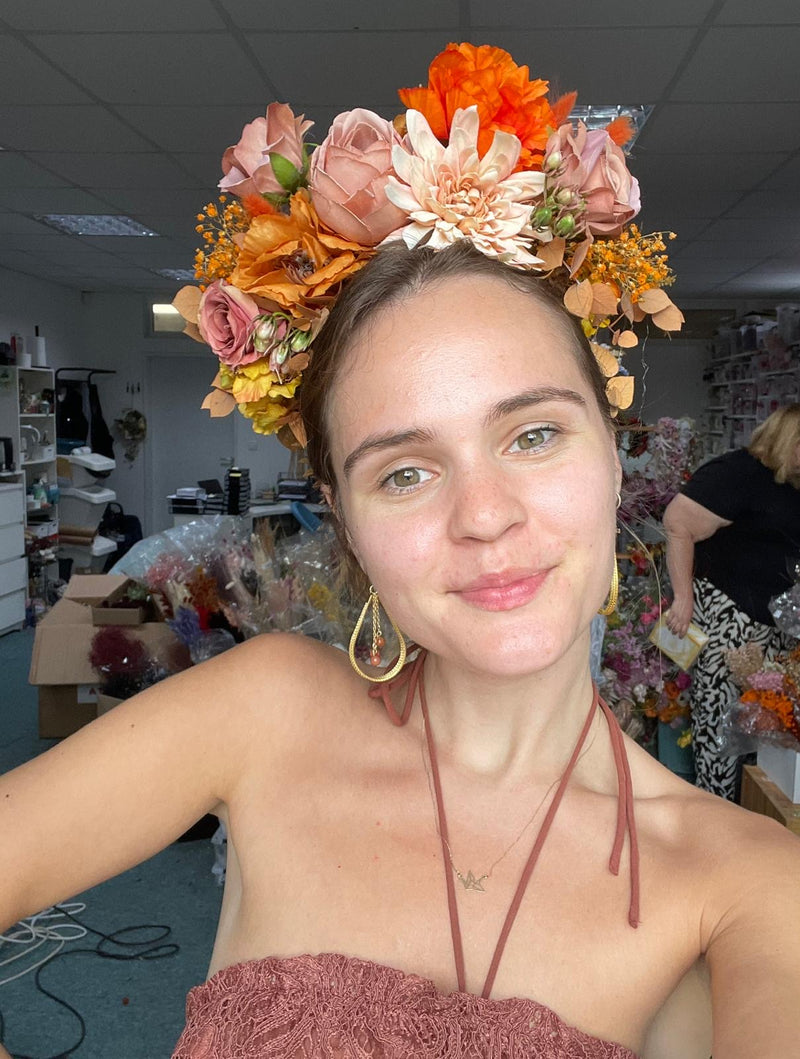 Woman wearing a floral headpiece in an indoor setting