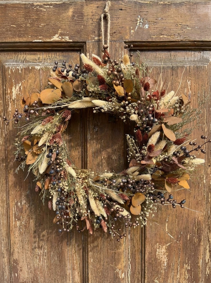 Measuring approximately 45 cm in diameter, this wreath makes a lovely focal point on an interior door or wall. Picture it above a wooden console with a favourite ceramic vase nearby, adding a little warmth to the place where you pause at the end of the day.