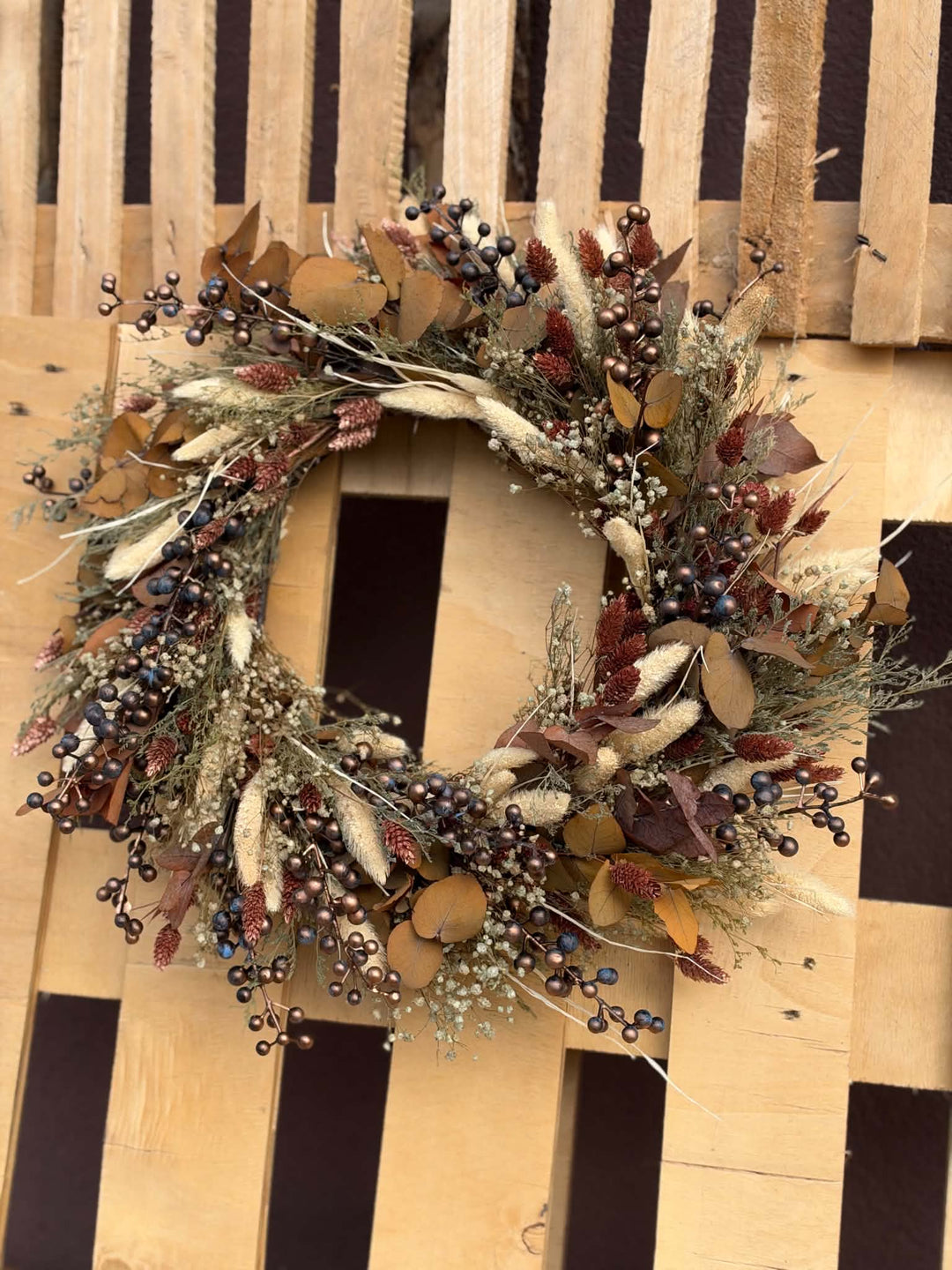 Measuring approximately 45 cm in diameter, this wreath makes a lovely focal point on an interior door or wall. Picture it above a wooden console with a favourite ceramic vase nearby, adding a little warmth to the place where you pause at the end of the day.