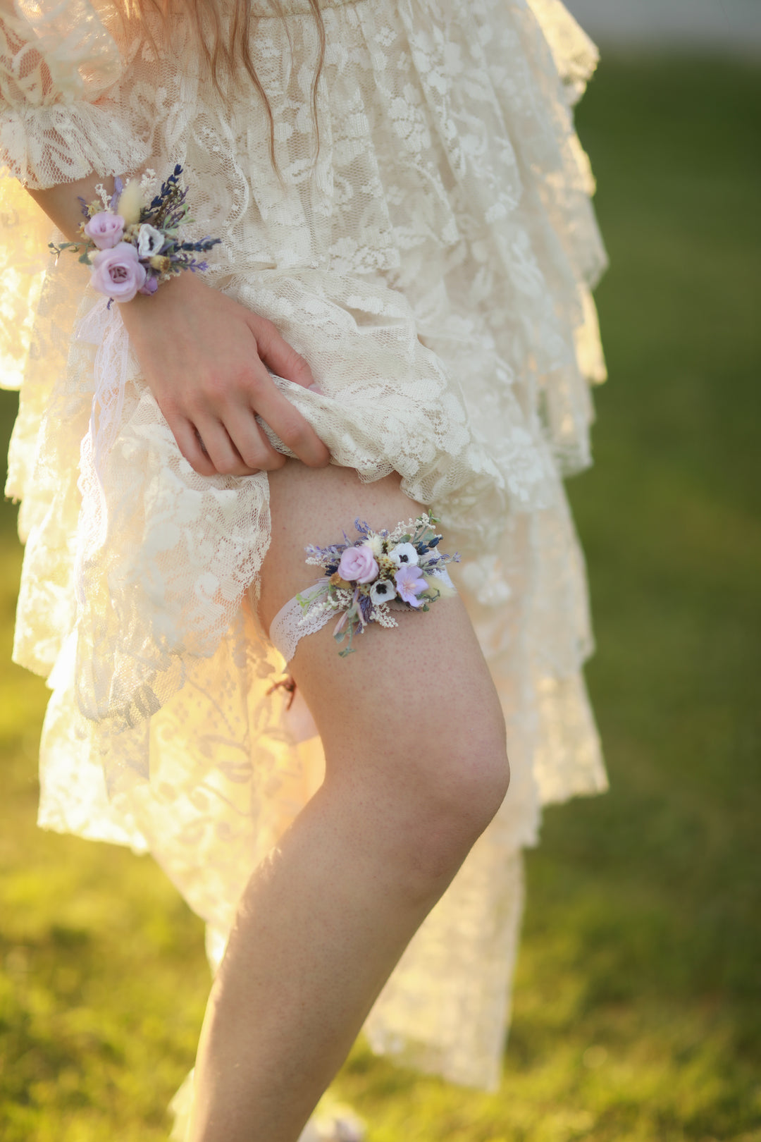 Person wearing a floral wrist corsage in a natural setting