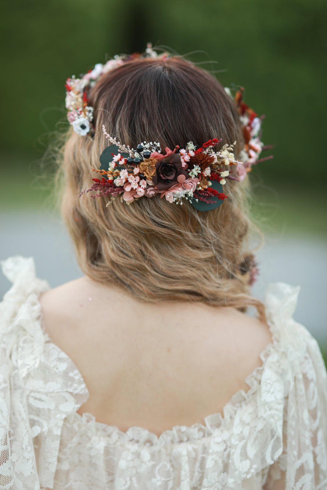 Blush and burgundy bridal hair comb with roses, white anemones, red dried florals and eucalyptus worn in bridal updo, handmade by Magaela