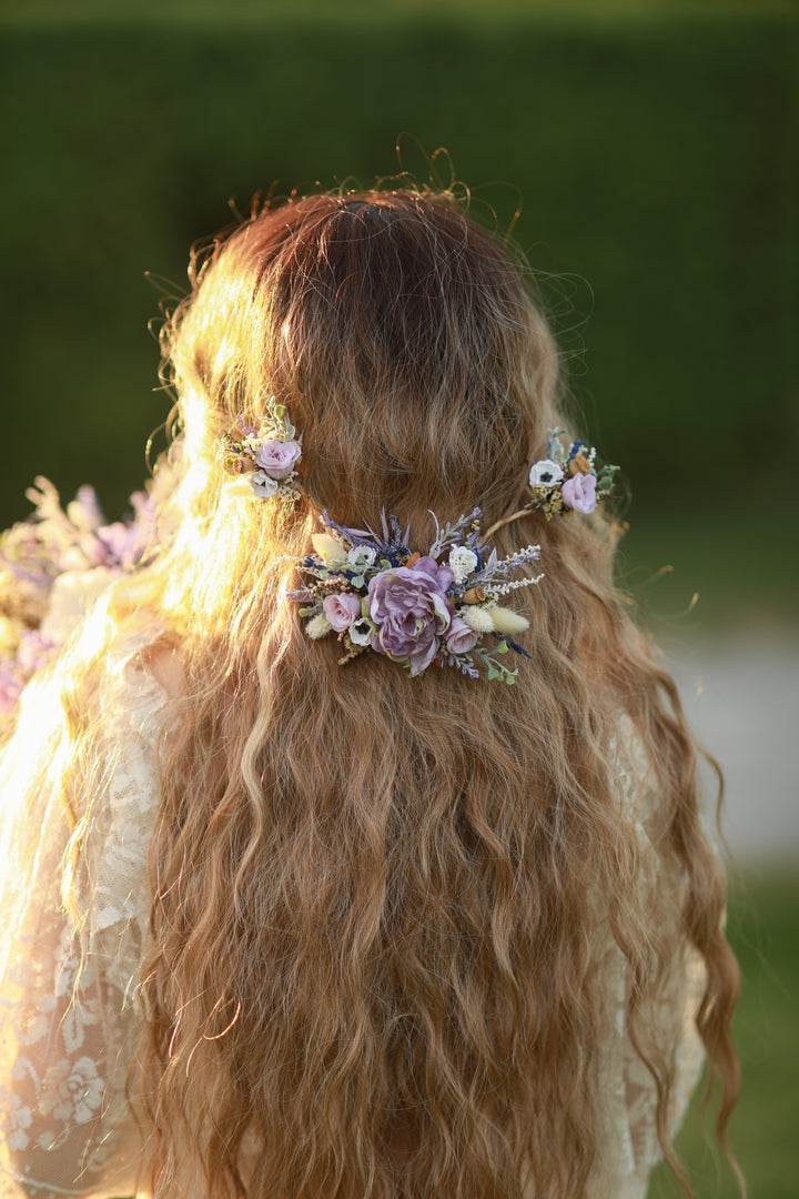 Person with flora purple l hair accessories in a natural setting