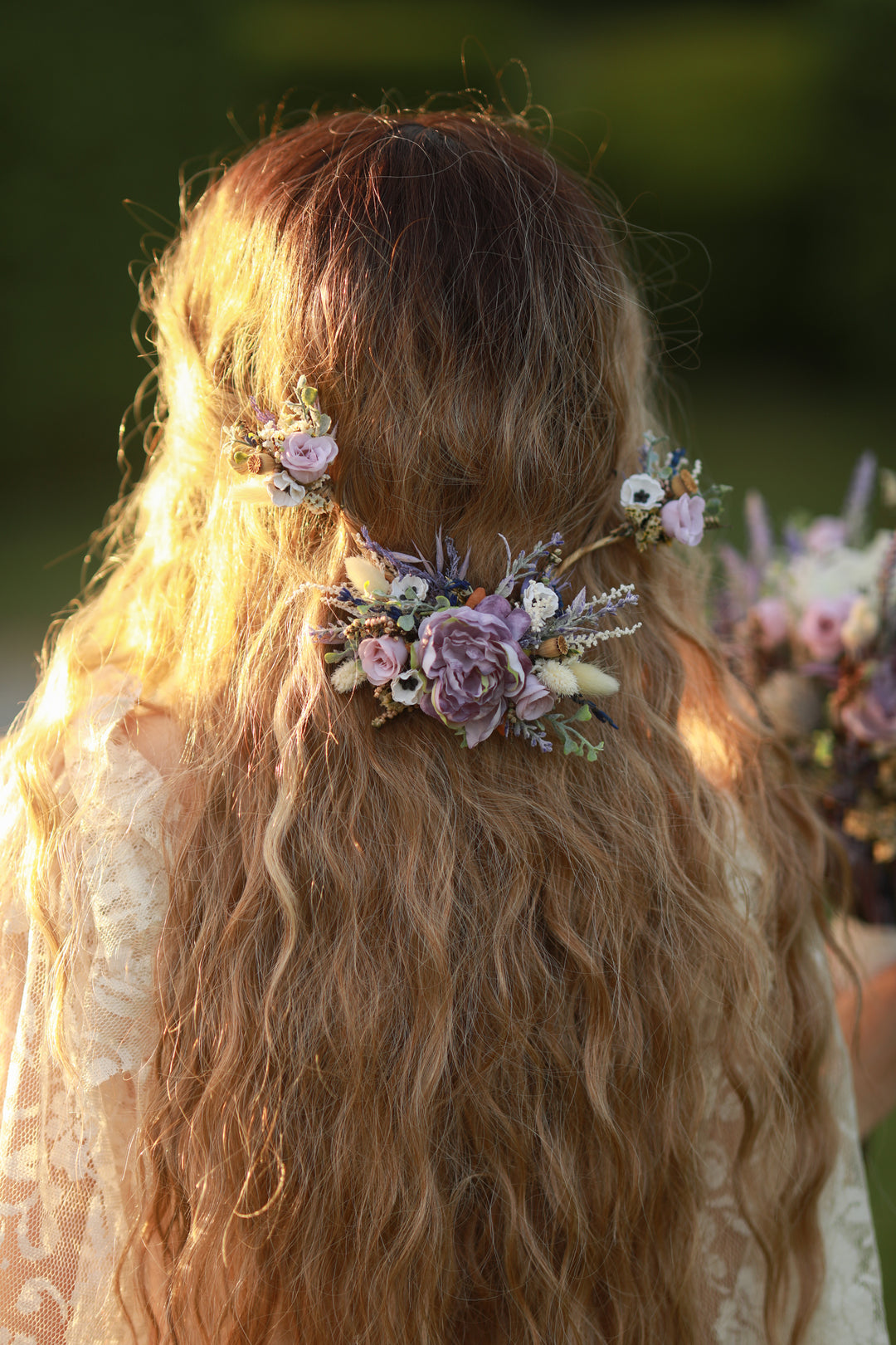 Person with long hair wearing floral hair accessories in a natural setting