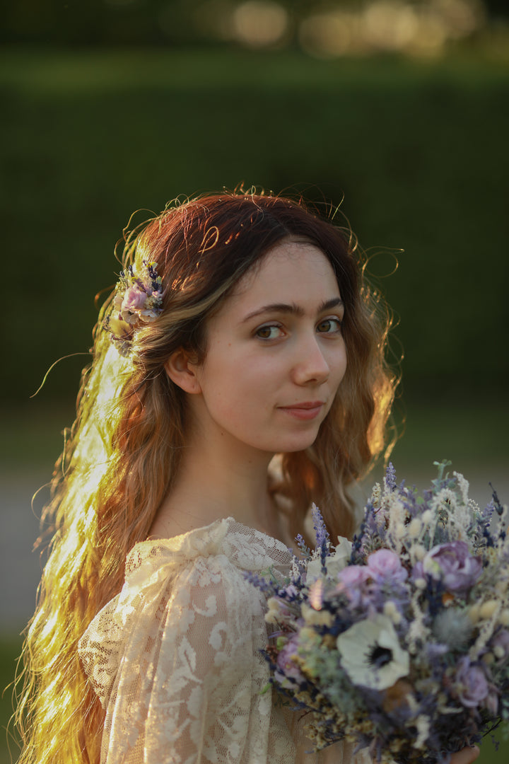 Woman with floral headpiece and bouquet in a natural setting