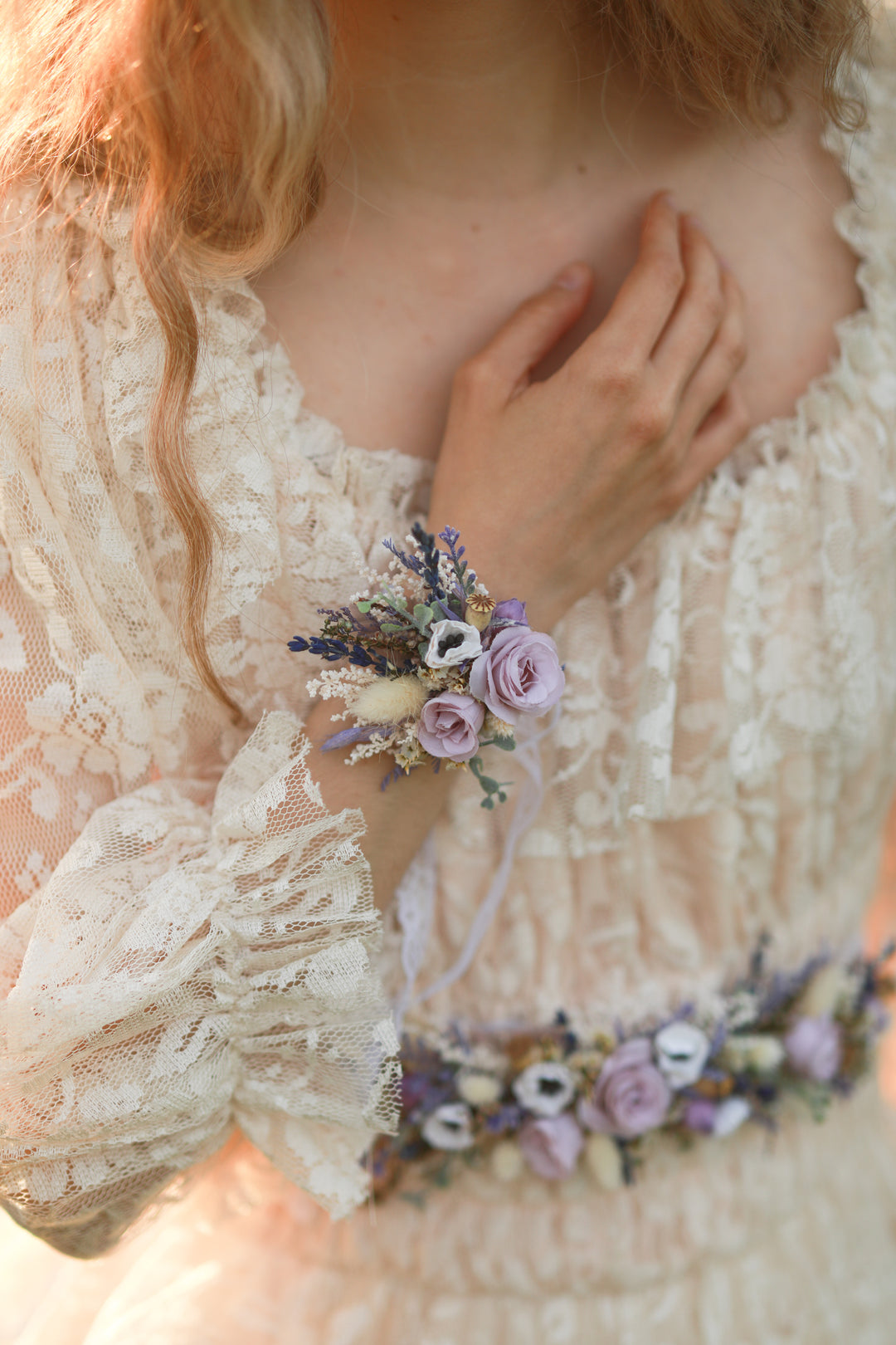 Person wearing a floral wrist corsage with a soft focus background