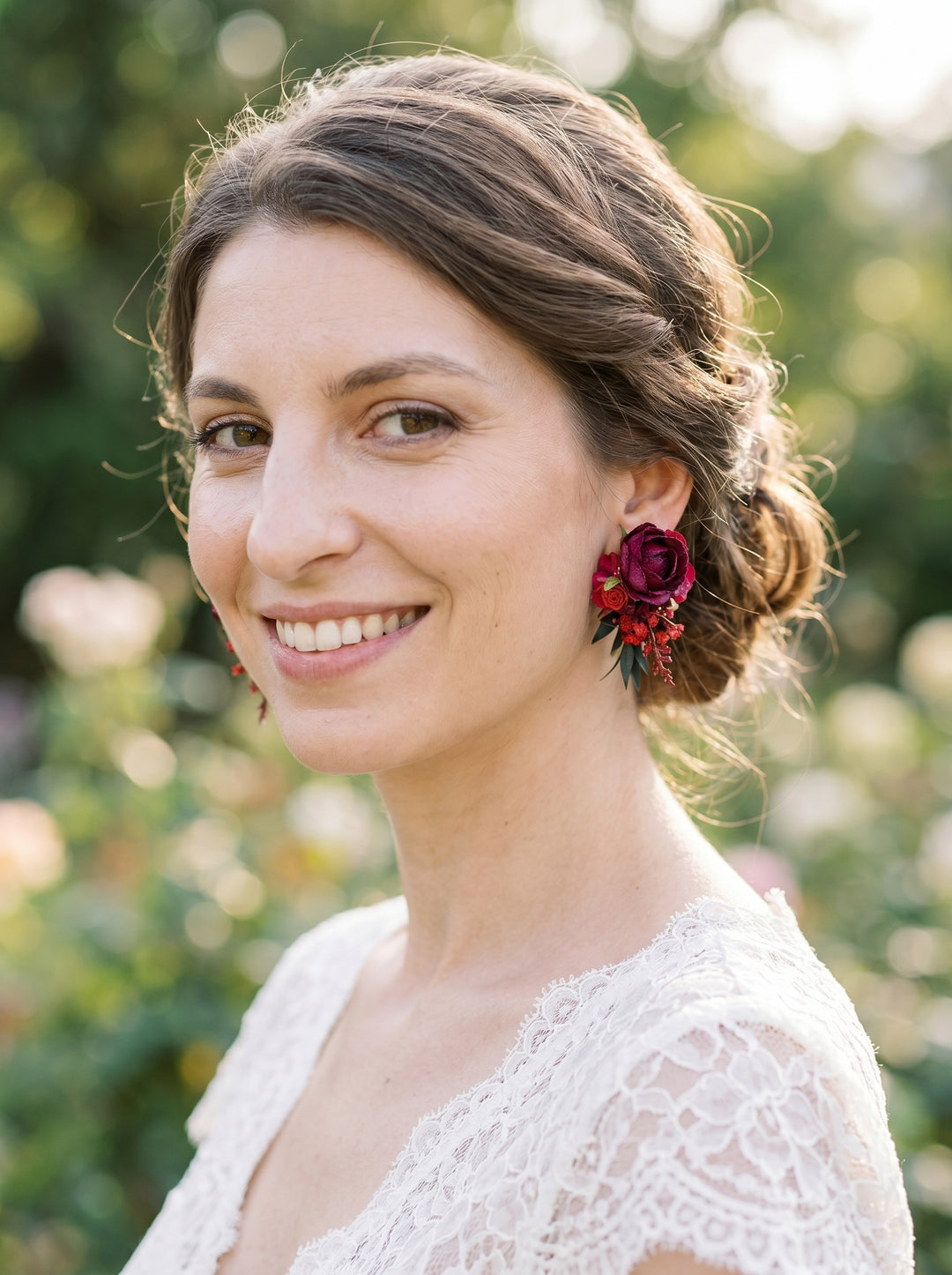 Woman wearing floral earrings with a blurred natural background