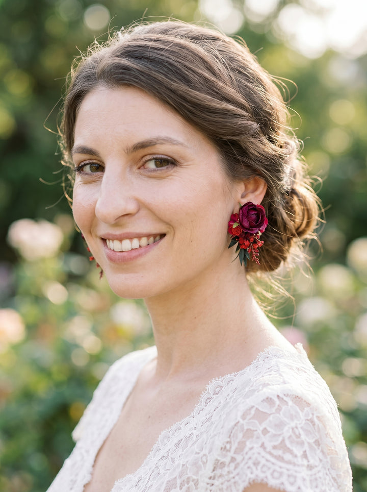 Woman wearing floral earrings with a blurred natural background