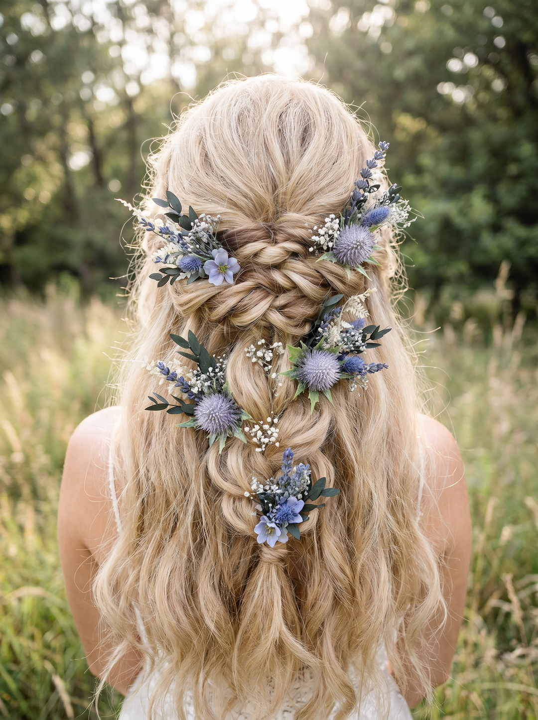 Blonde hair styled in a braid with floral boho hairpins with thistles in a natural setting