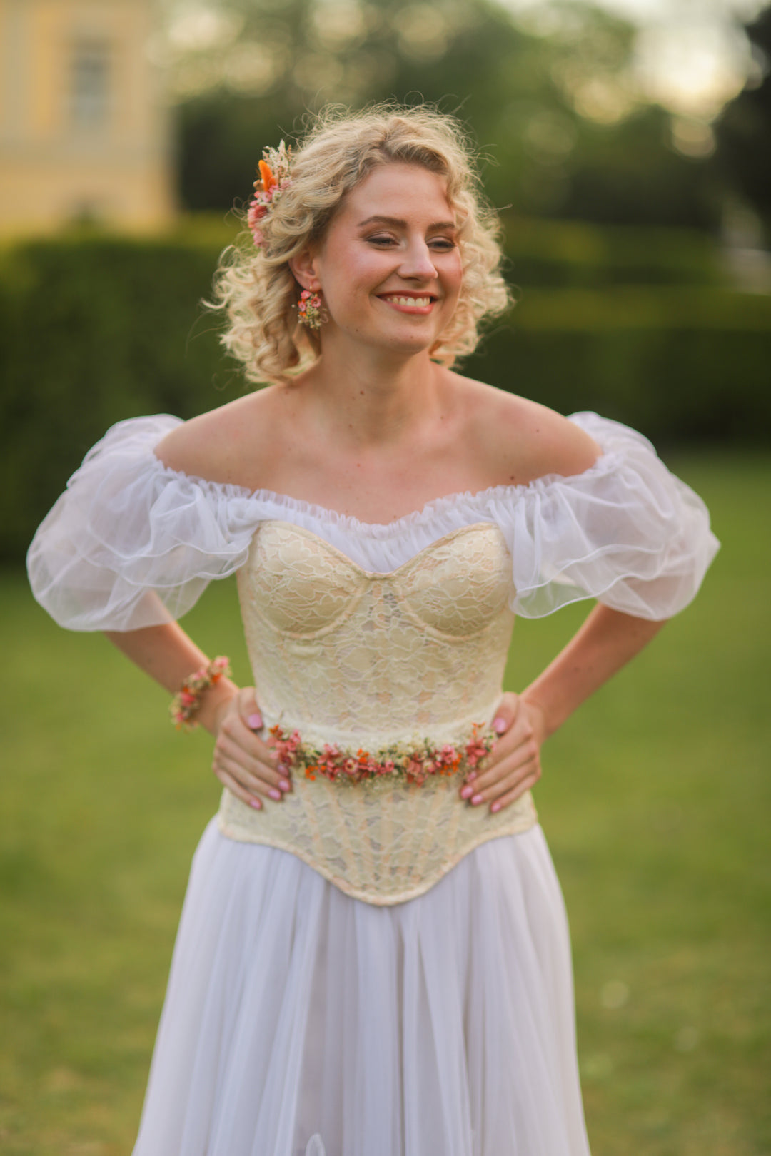 Woman wearing a vintage-style dress with puffed sleeves in an outdoor setting