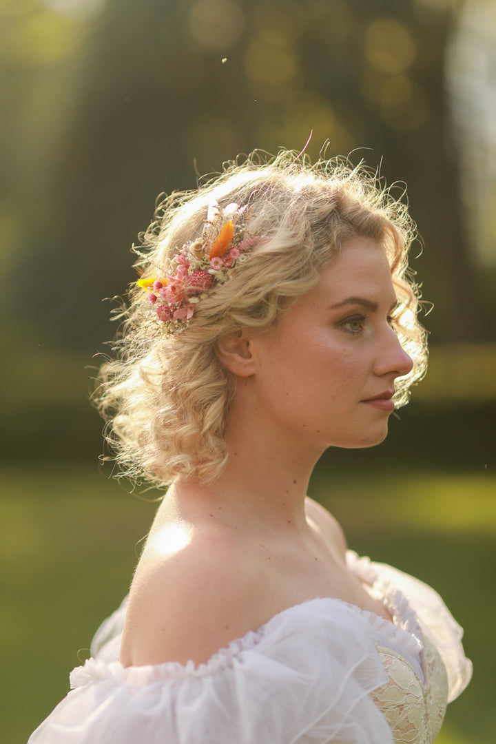 Woman with floral dried hair comb in a natural setting