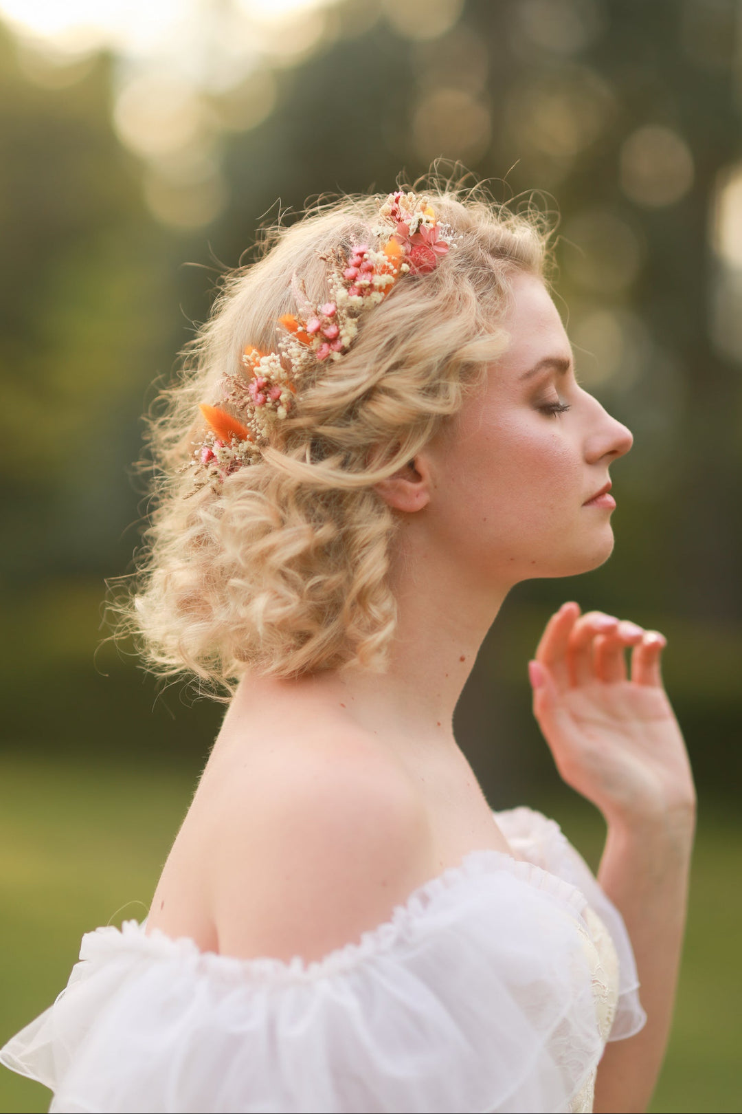 Woman with floral hair pins in a natural setting