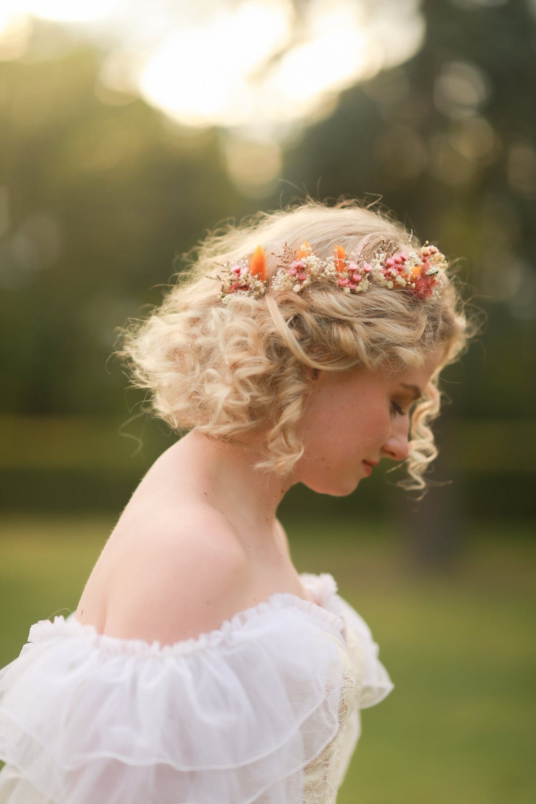Woman with floral hairpiece in a natural setting