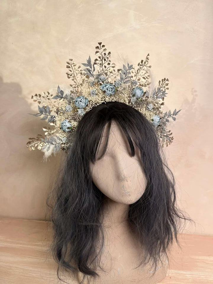 Mannequin head with intricate floral headpiece in boho style  on a beige background