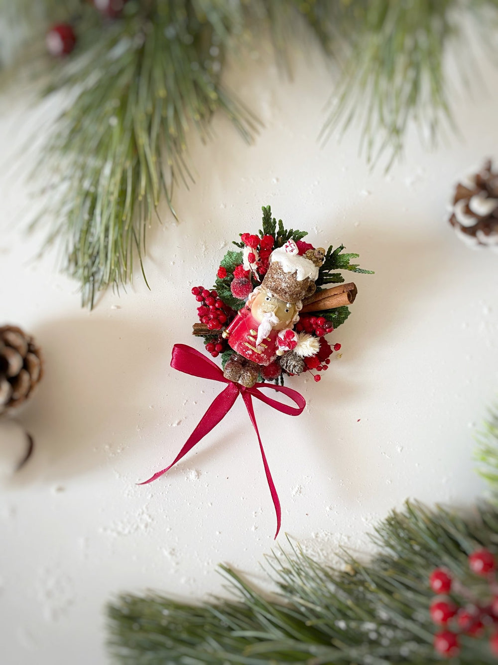  Limited edition handmade Nutcracker Christmas brooch with red berries, pine cones, cinnamon and a bow for coats, hats and scarves