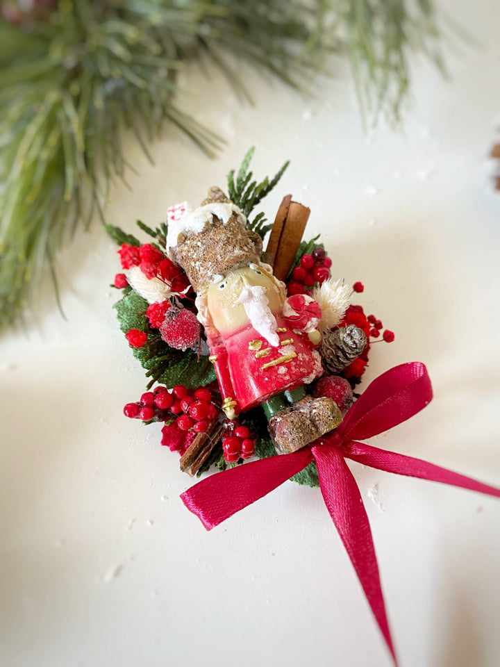  Limited edition handmade Nutcracker Christmas brooch with red berries, pine cones, cinnamon and a bow for coats, hats and scarves