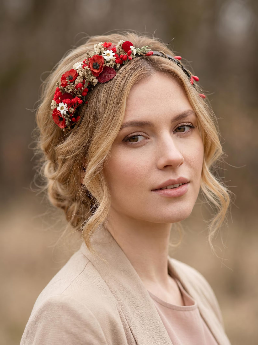 Woman wearing a floral headband with red and white flowers in a natural setting