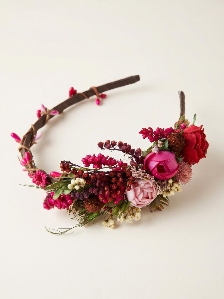 Floral headband with pink and red flowers on a white background