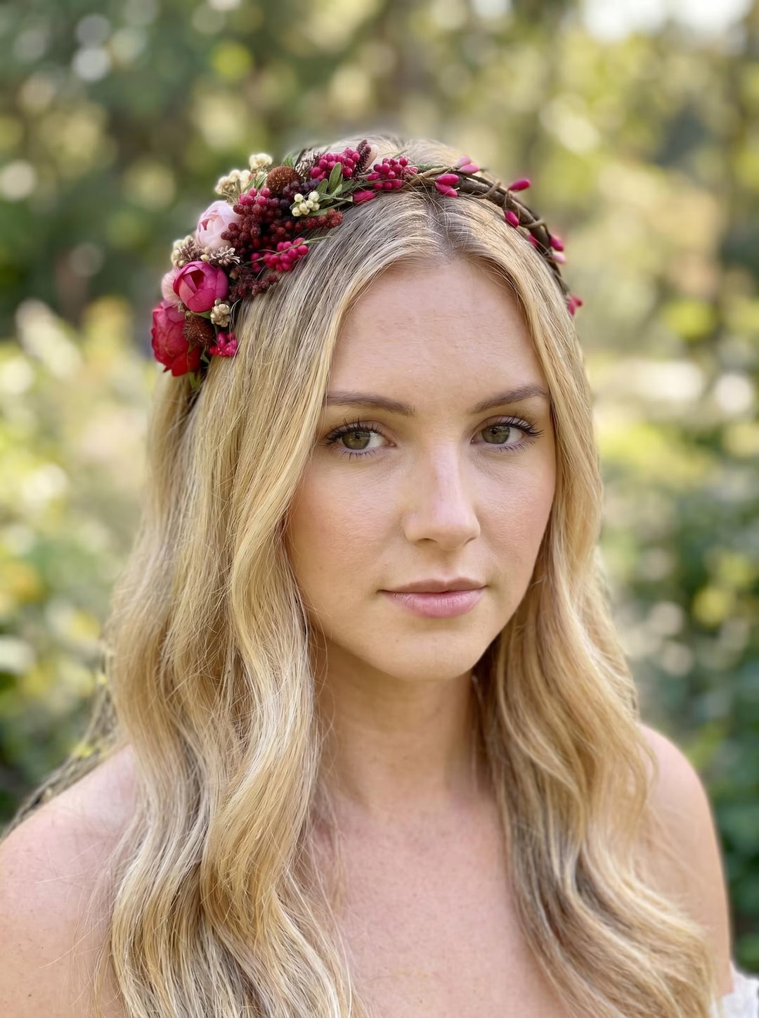 Woman wearing a floral headband with a blurred natural background