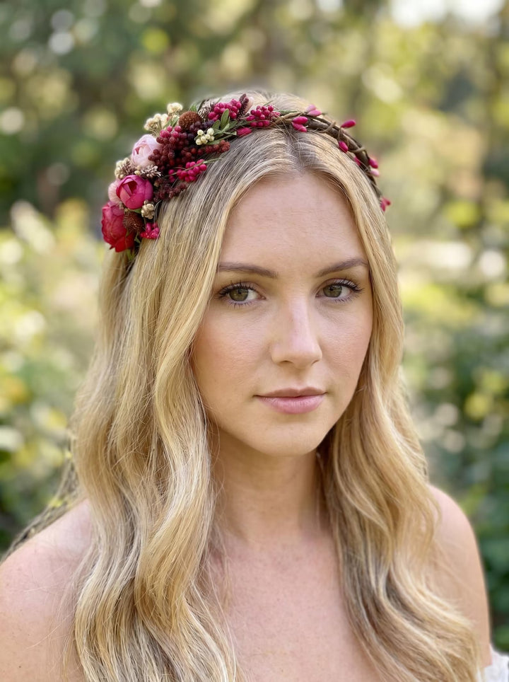 Woman wearing a floral headband with a blurred natural background