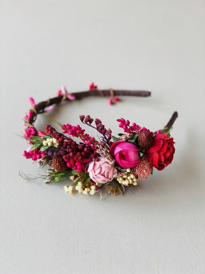 Floral headband with pink and red flowers on a light gray background