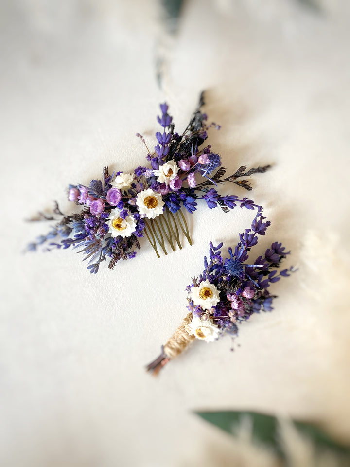 A dried floral hair comb and matching corsage set featuring purple lavender sprigs, white daisies with yellow centers, and small pink blossoms on a soft cream background.