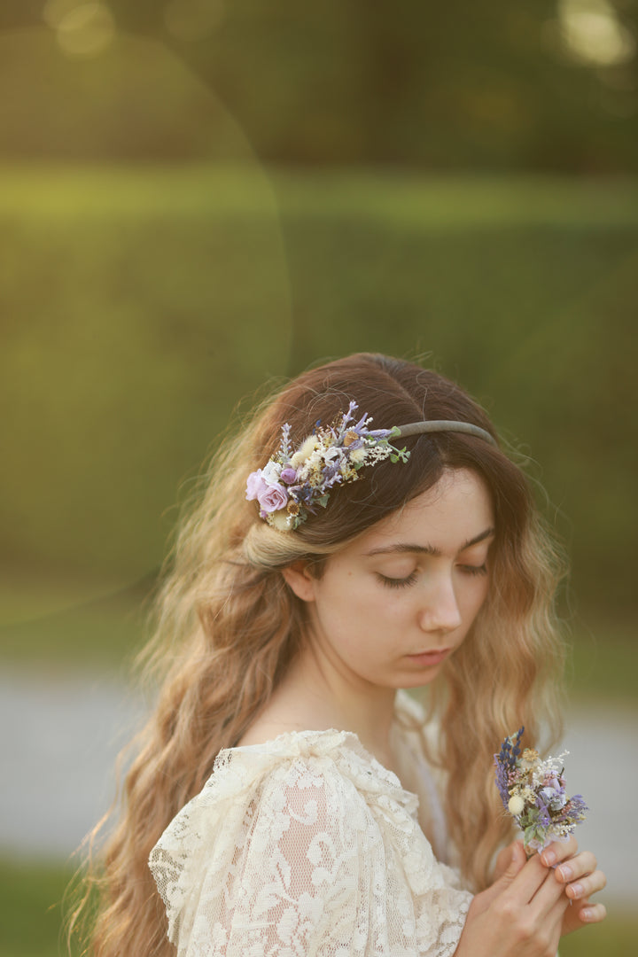 Woman with floral headband and hair accessories in a natural setting