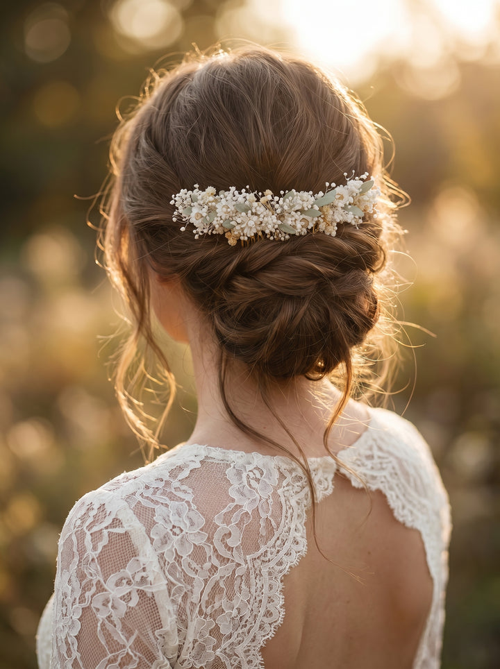 Woman wearing a floral hair comb in natural white tones with a blurred natural background