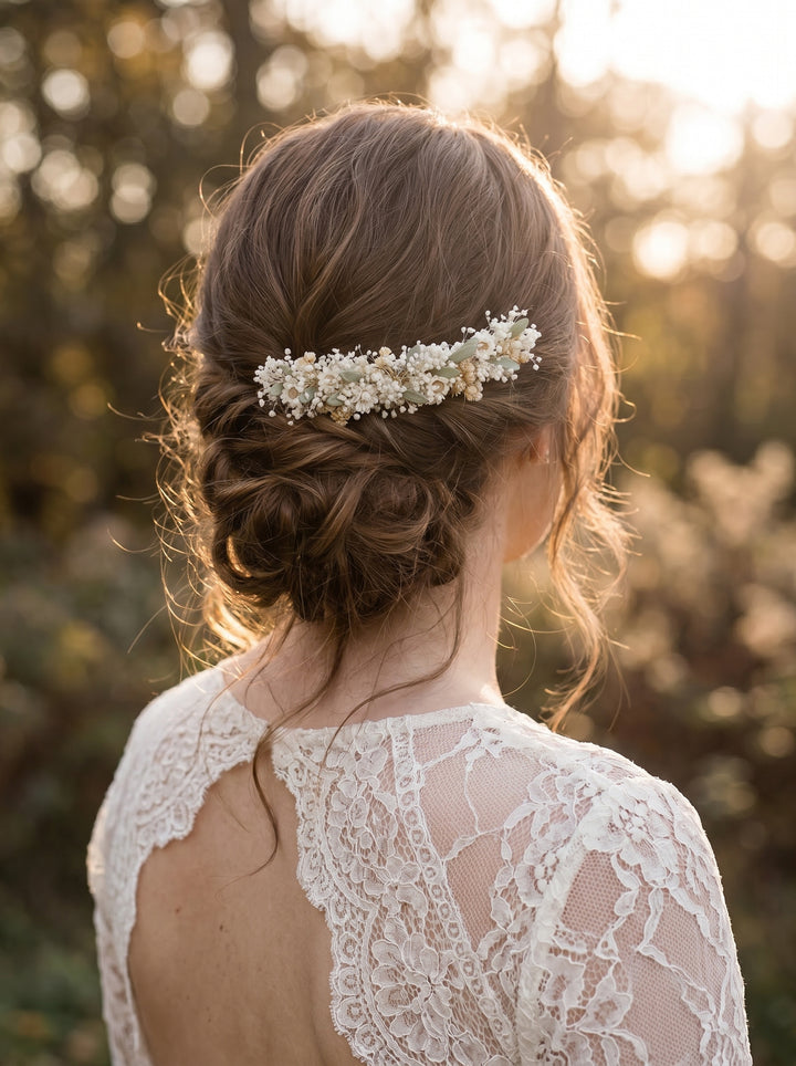 Woman with elegant hair comb and lace dress against a blurred natural background