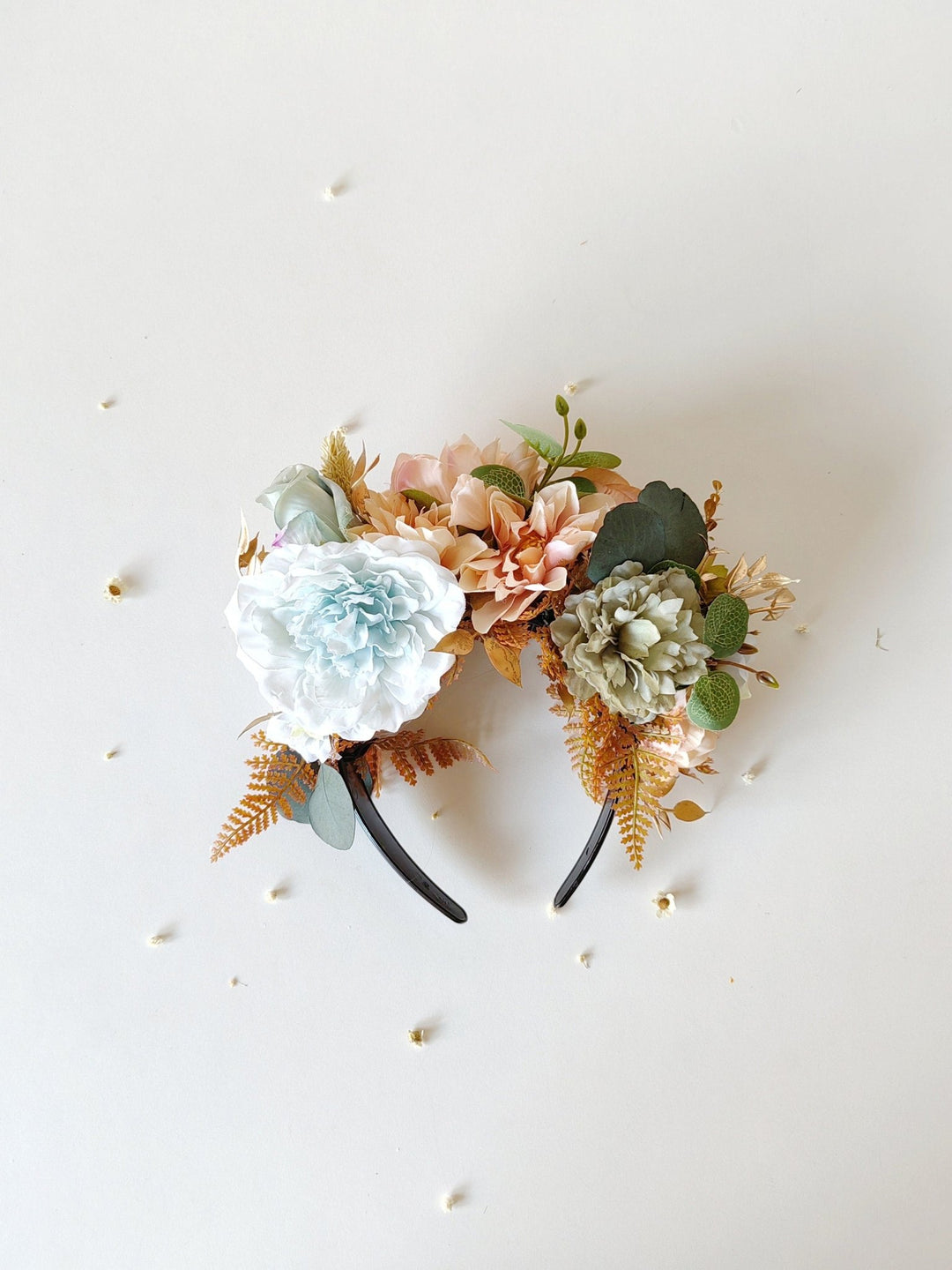 Floral headband with white, pink, and green flowers on a white background