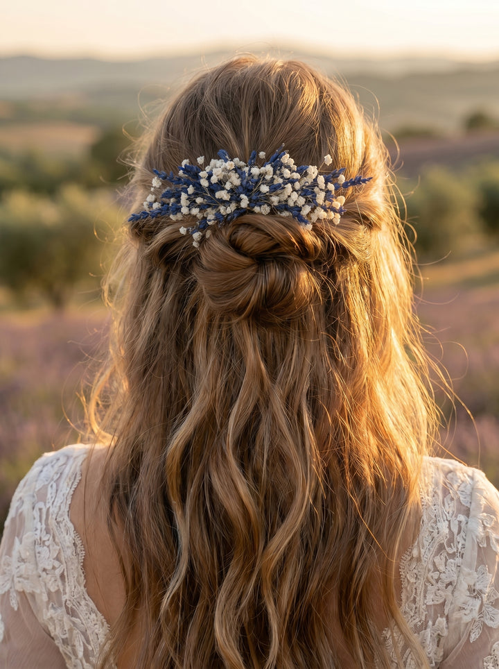 Woman with braided hair and floral hair comb with lavender and baby´s breath in a field at sunset
