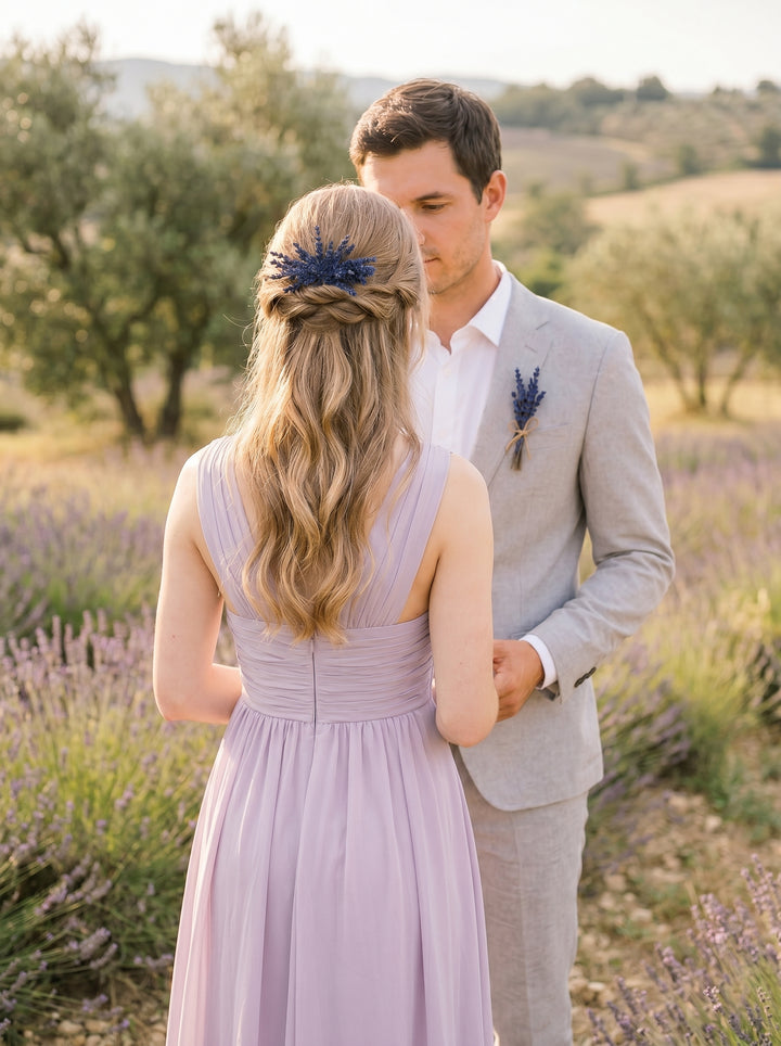Man and woman standing in a lavender field, both wearing formal attire.