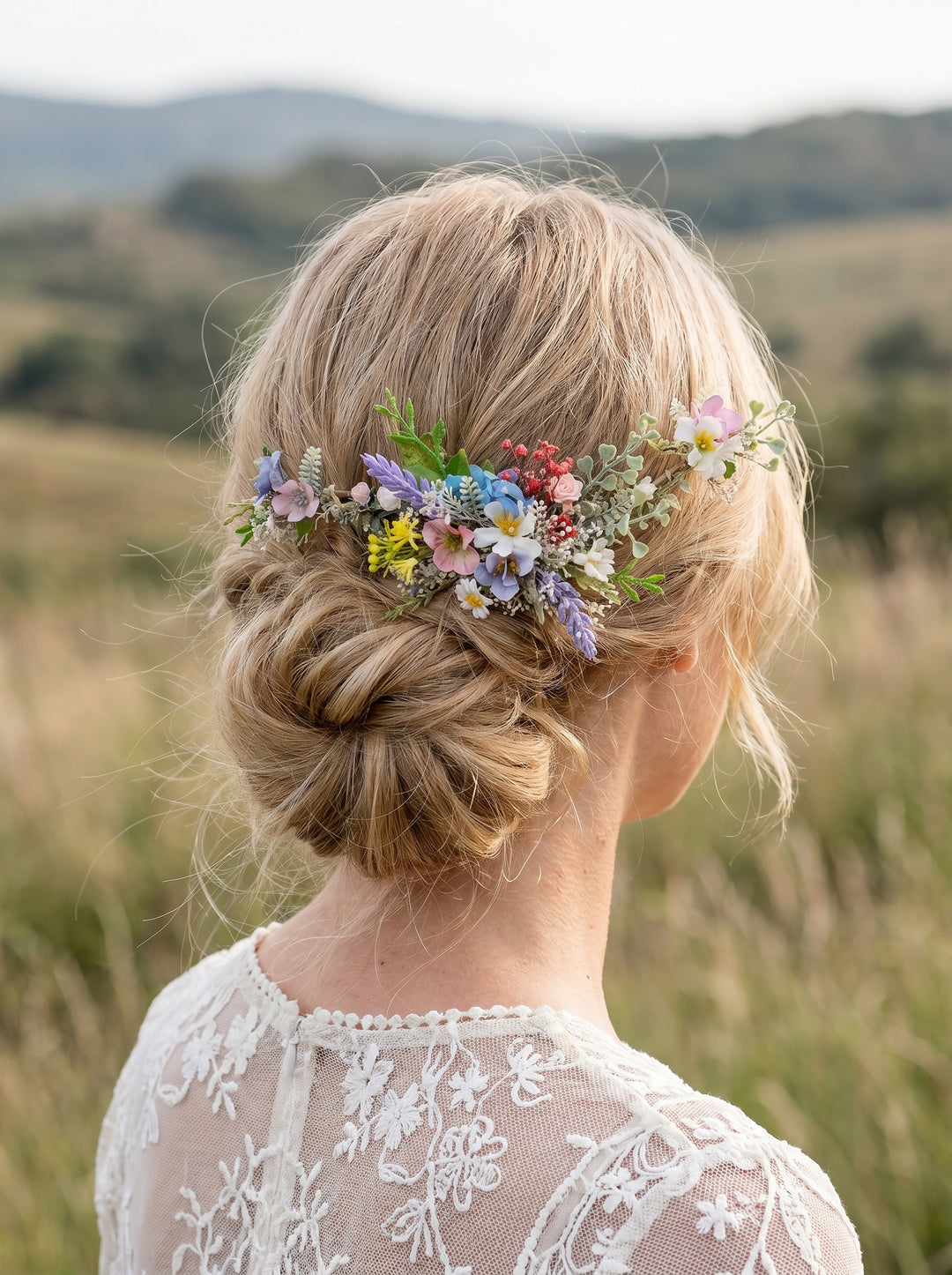 Woman with a bun hairstyle decorated with colorful wildflower hair vine in a natural setting