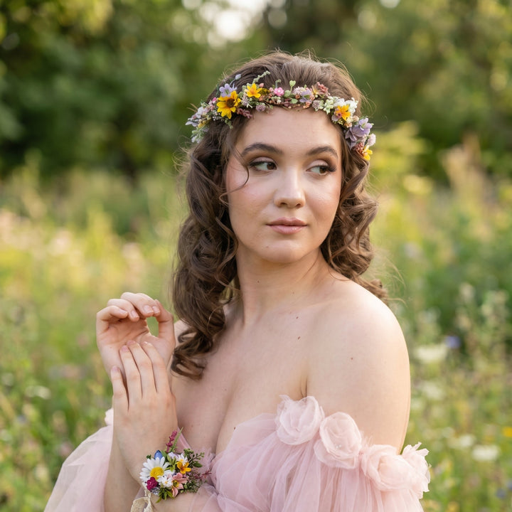 Woman with a floral wildflowers crown and dress in a natural setting