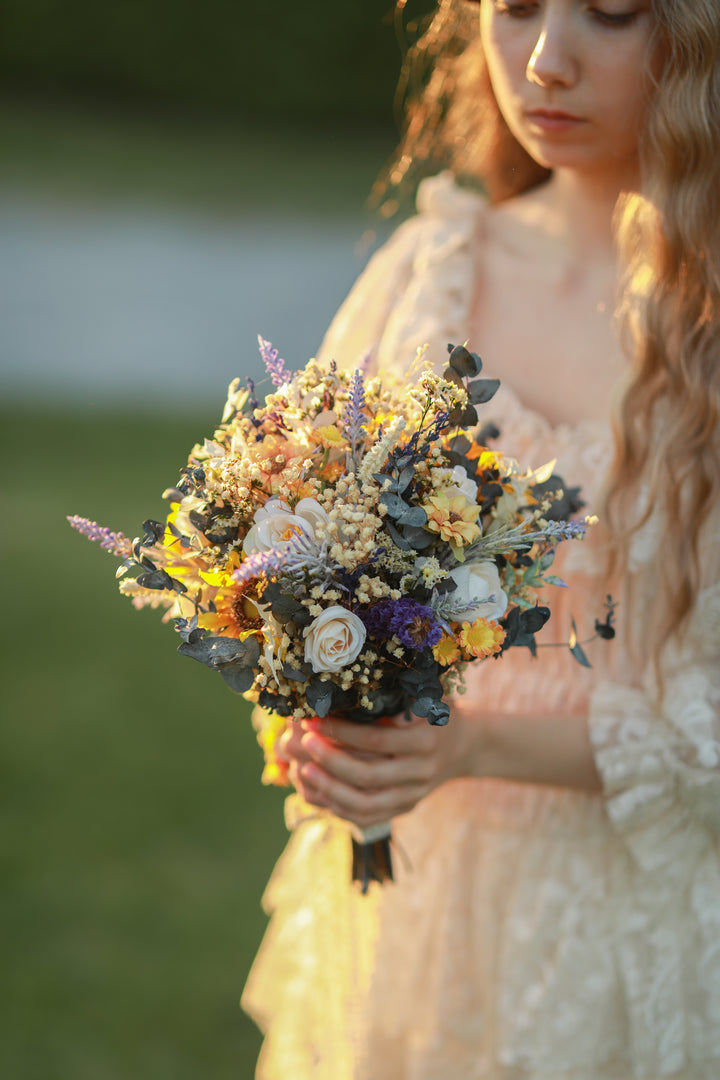 Woman holding a bouquet of flowers with a blurred natural background