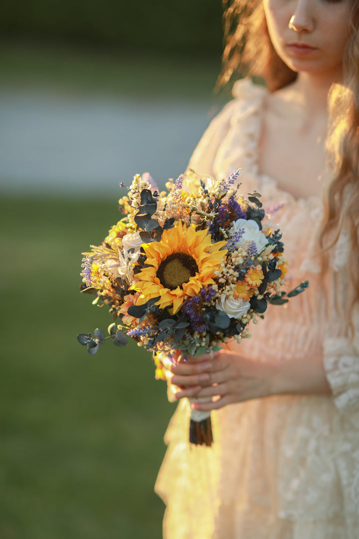 Woman holding a bouquet of flowers outdoors with a blurred background