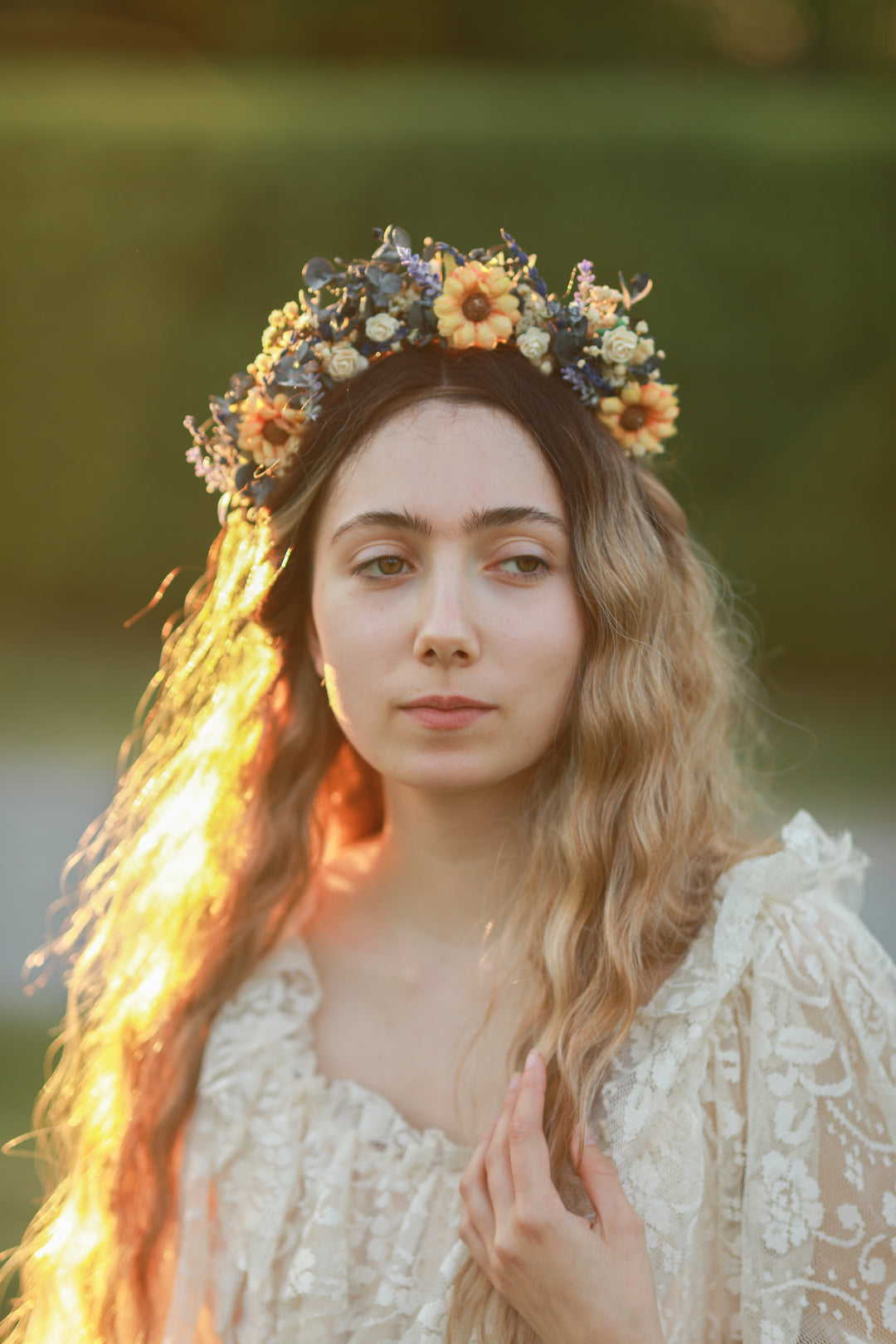 Woman with a floral sunflower crown in a natural setting