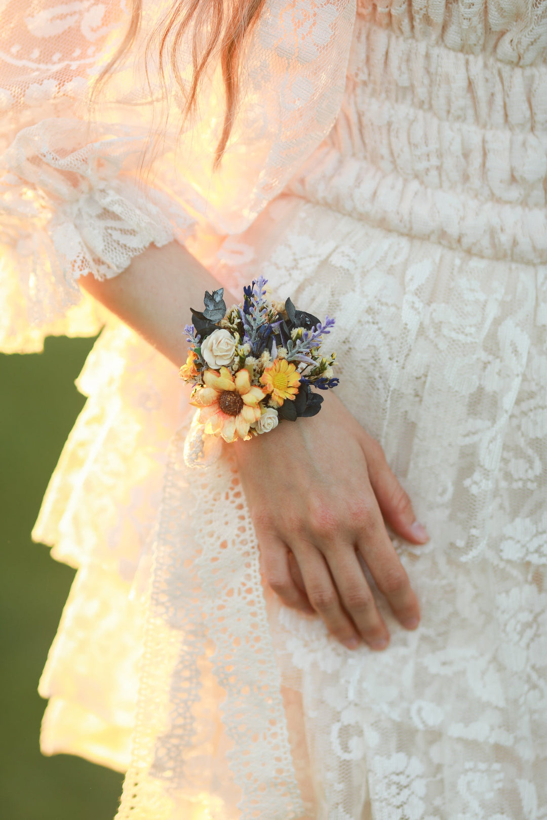 Person wearing a floral wrist corsage with a blurred background