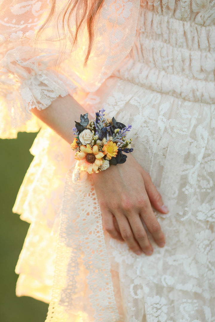 Person wearing a floral wrist corsage with a blurred background