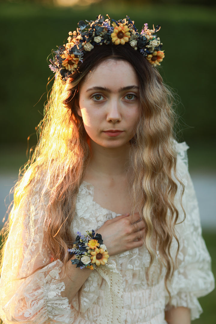 Woman wearing a floral crown and holding a matching bracelet outdoors
