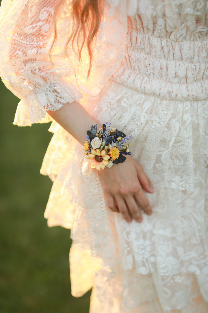 Person wearing a floral wrist corsage with a blurred background