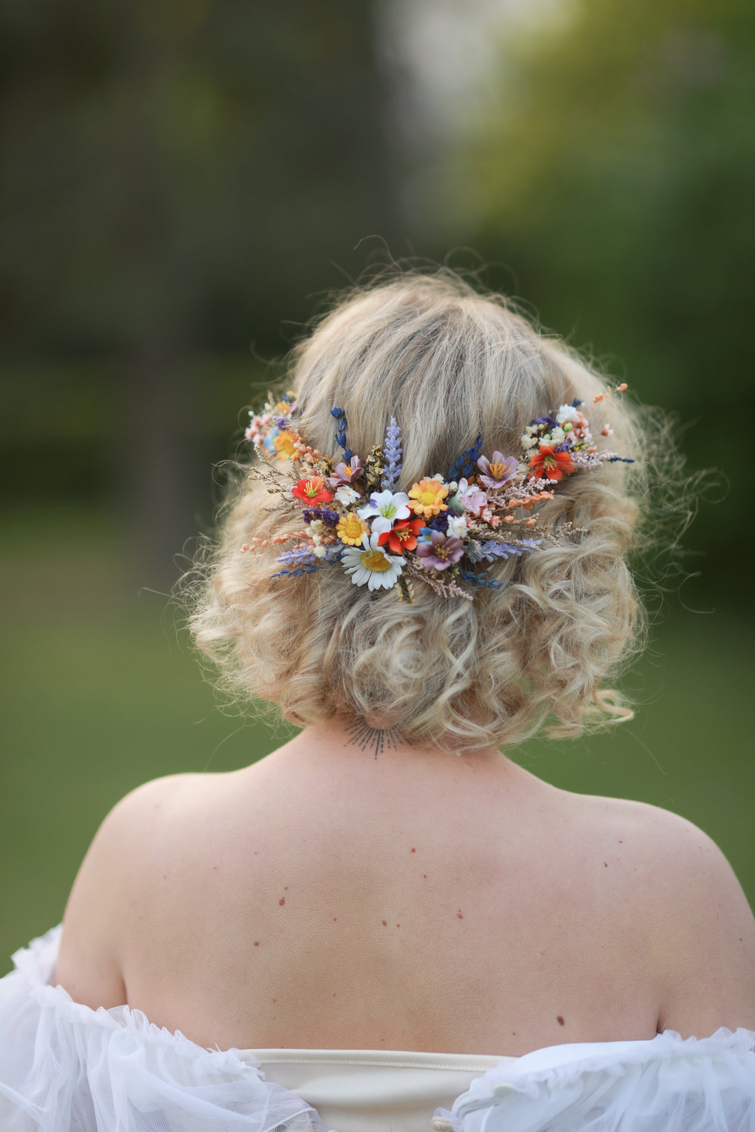 Person with floral wildflowers hairpiece outdoors