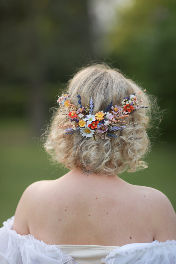 Person with floral wildflowers hairpiece outdoors