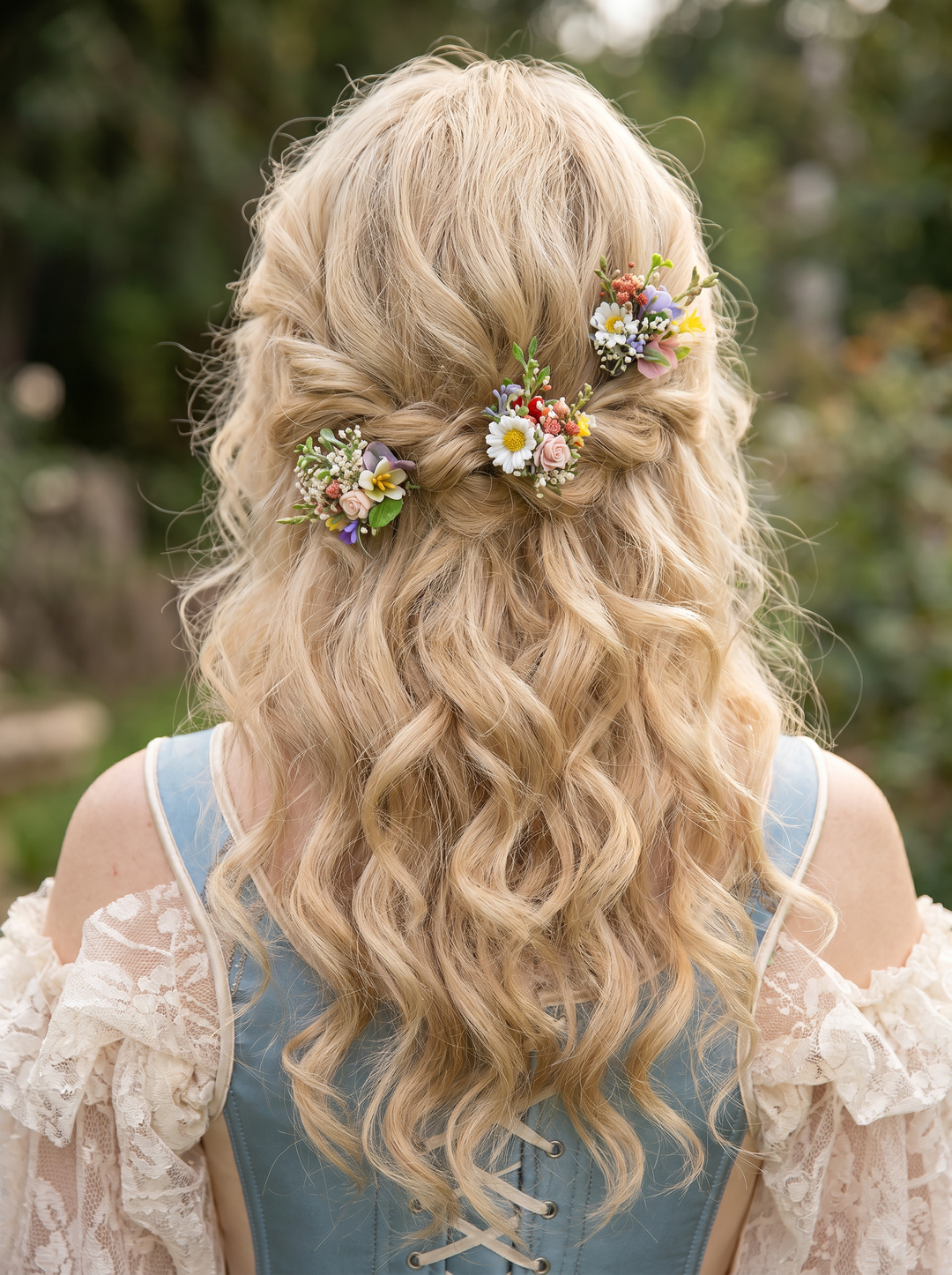 Blonde hair with floral hairpins against a blurred natural background